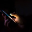 person texting in dark