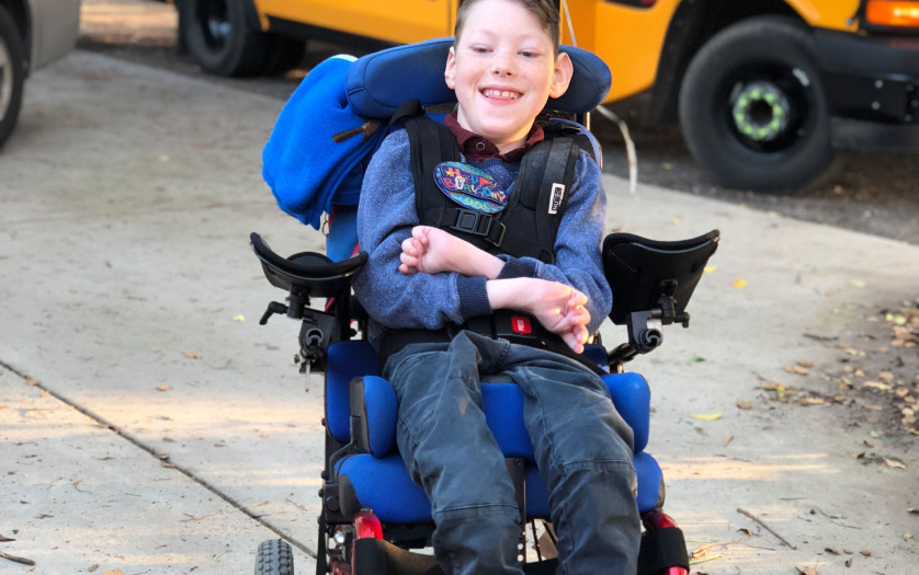 smiling boy in wheelchair