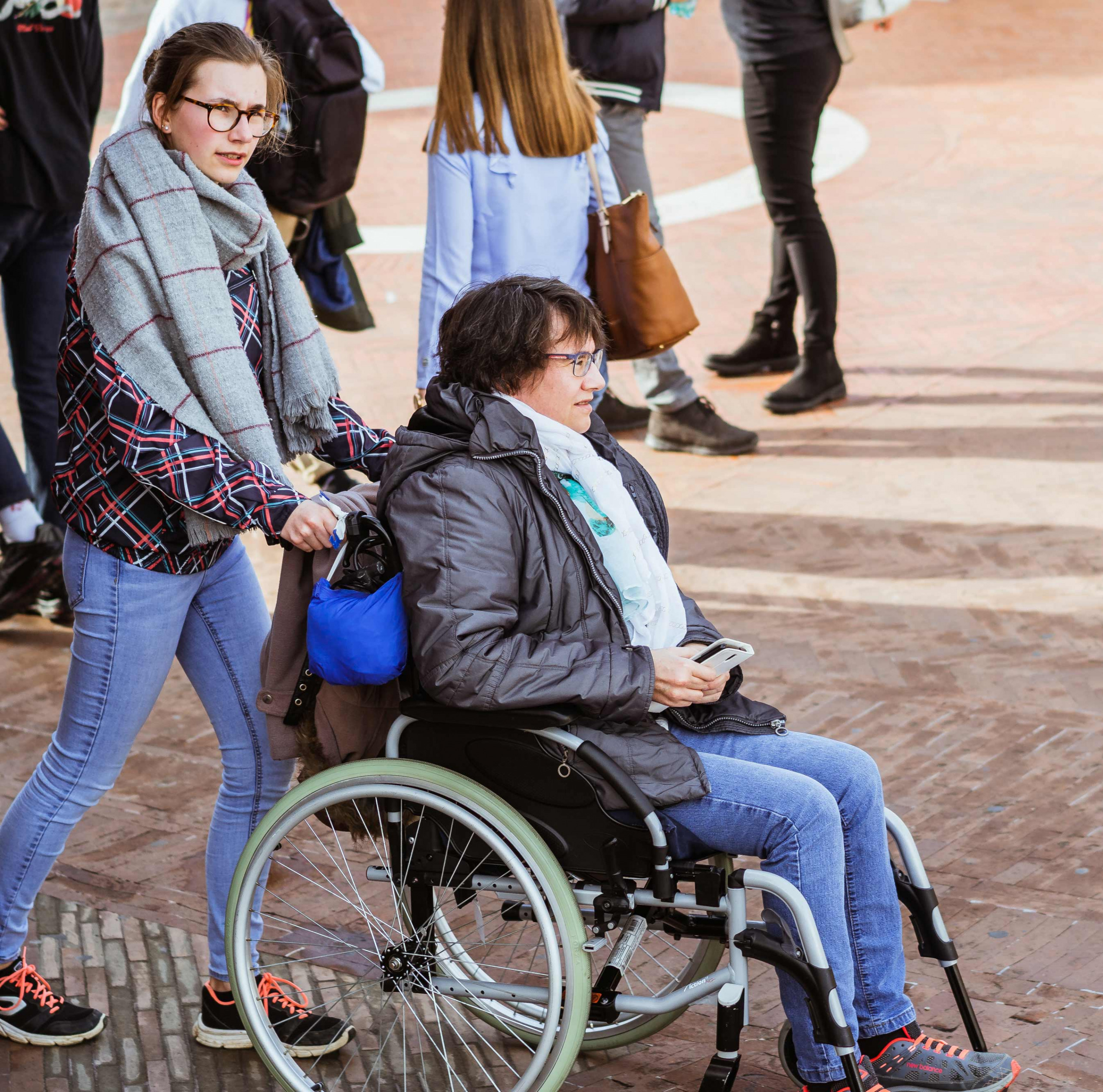 woman pushing wheelchair