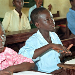 Portrait of a boy who answers a question in sign language In a classroom at the School for the Deaf.