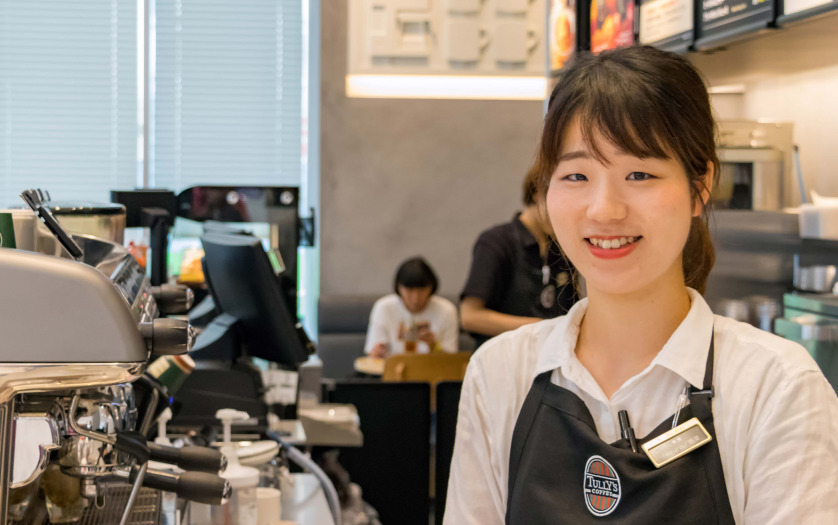 Japanese female barista smiling looking camera at a coffee shop in Hiroshima, Japan.