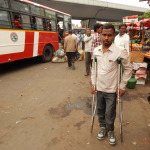 young man with disability wait for bus in a bus terminal
