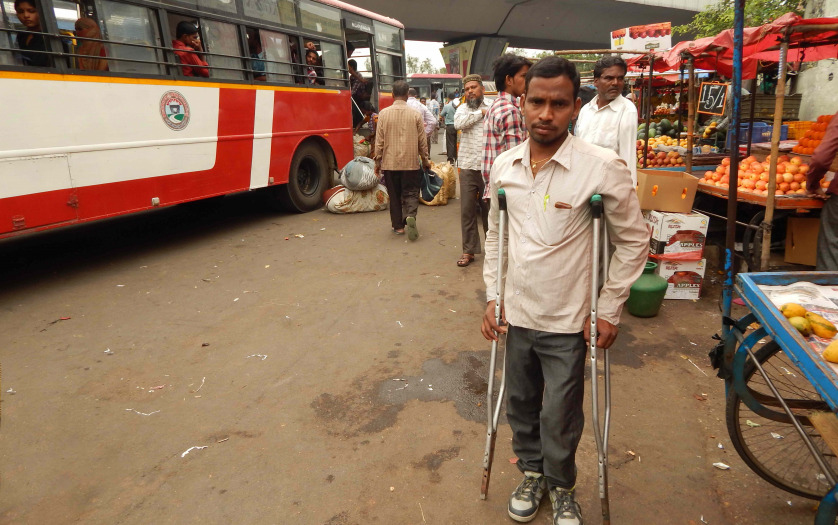 young man with disability wait for bus in a bus terminal