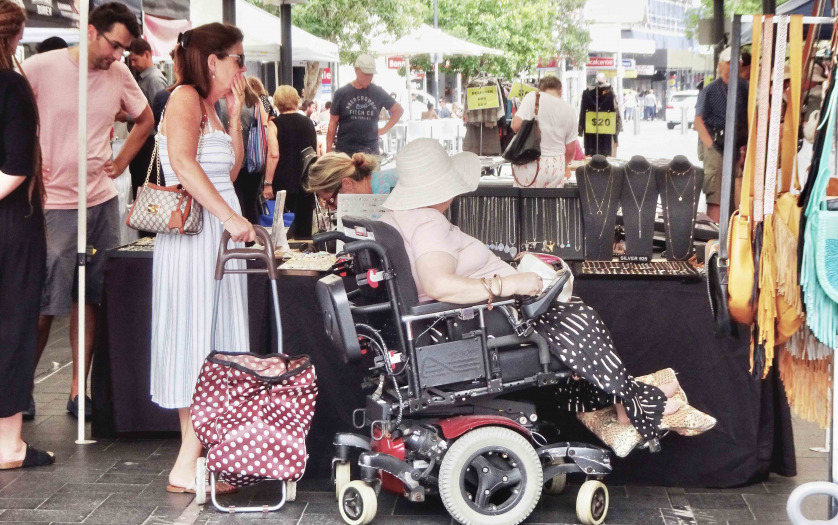 senior woman shopping in her wheelchair at the markets.
