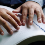 blind person reading braille