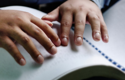 blind person reading braille
