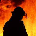One firefighter rescue worker at wild fire blaze.