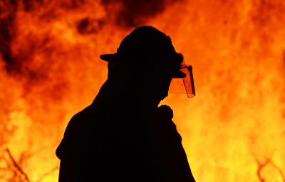 One firefighter rescue worker at wild fire blaze.