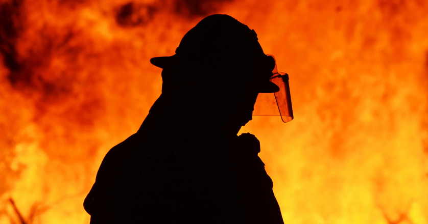 One firefighter rescue worker at wild fire blaze.