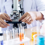 Scientist using a microscope for product inspection