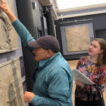 Visitor touches exhibit piece