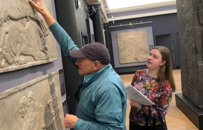 Visitor touches exhibit piece