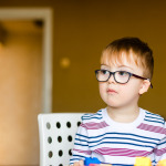 Little boy in the glasses with disability