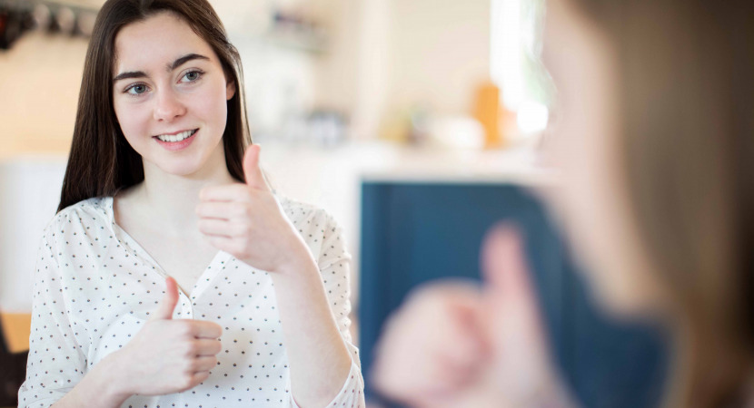 Teenage Girls Having Conversation Using Sign Language