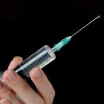 Hand of medic with syringe