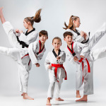 studio shot of group of kids training karate martial arts