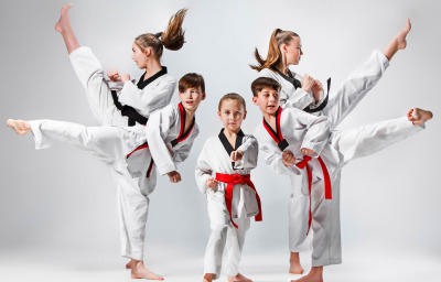 studio shot of group of kids training karate martial arts