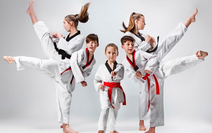 studio shot of group of kids training karate martial arts