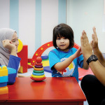 kid with autism with parents