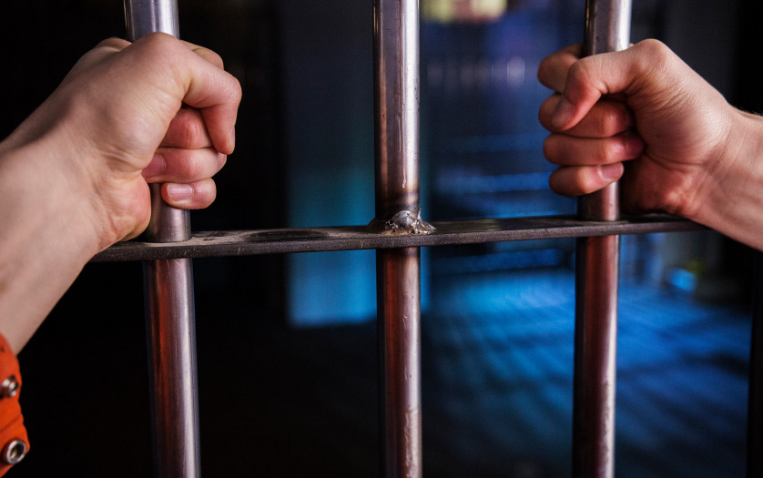 A man in jail - captive behind bars