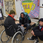 man in wheelchair with friends