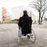 wheelchair user waiting to cross the street