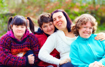 Portrait of happy women with disability having fun in spring park