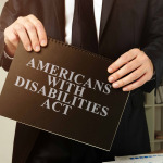 Lawyer holds Americans with Disabilities Act ADA black book.