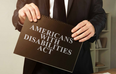 Lawyer holds Americans with Disabilities Act ADA black book.