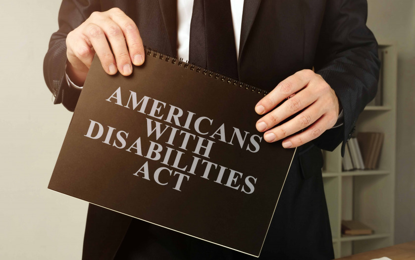 Lawyer holds Americans with Disabilities Act ADA black book.