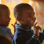 African kid smiling in the school