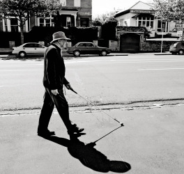 Blind man walks with a cane in Auckland street