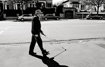 Blind man walks with a cane in Auckland street