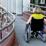 woman in wheelchair entering the building