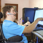 a person in wheelchair using computer