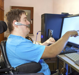 a person in wheelchair using computer