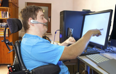 a person in wheelchair using computer