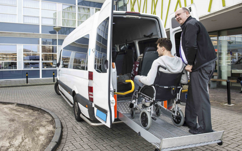 A driver helping the wheelchair user