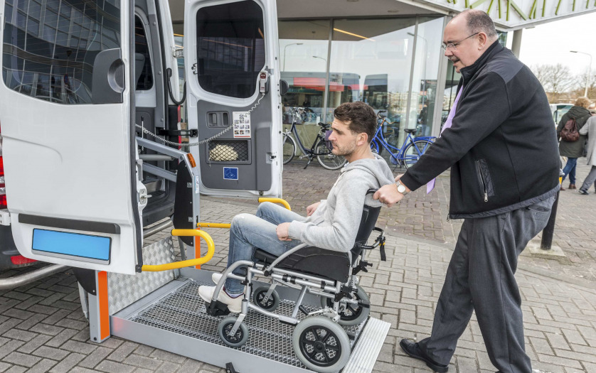 A driver helping the wheelchair user