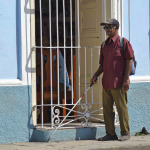 a blind person walking in the street