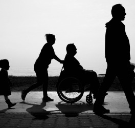 a family with a disabled in a wheelchair walking