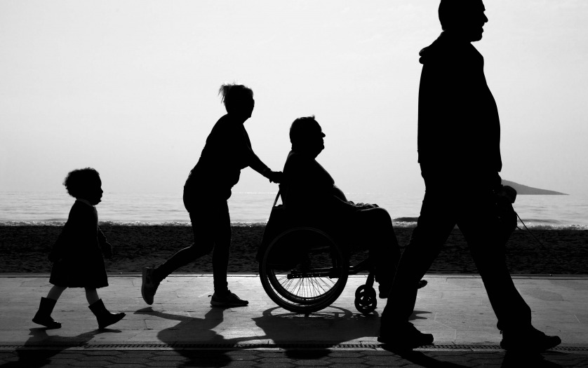 a family with a disabled in a wheelchair walking