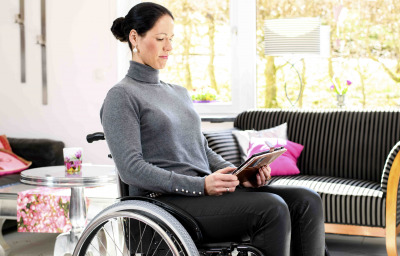 a woman in wheelchair reading