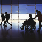 silhouette of man in wheelchair at airport