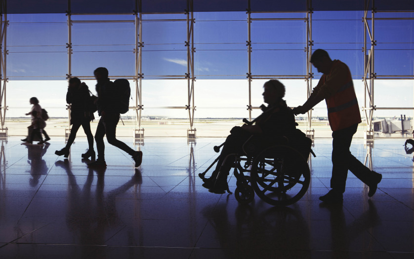 silhouette of man in wheelchair at airport