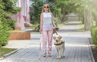 a blind woman walking in the street