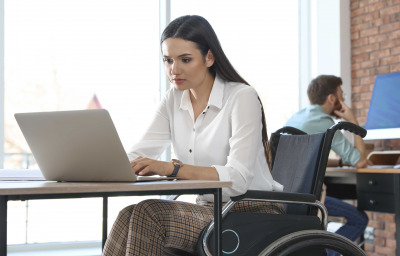 woman in wheelchair working on laptop