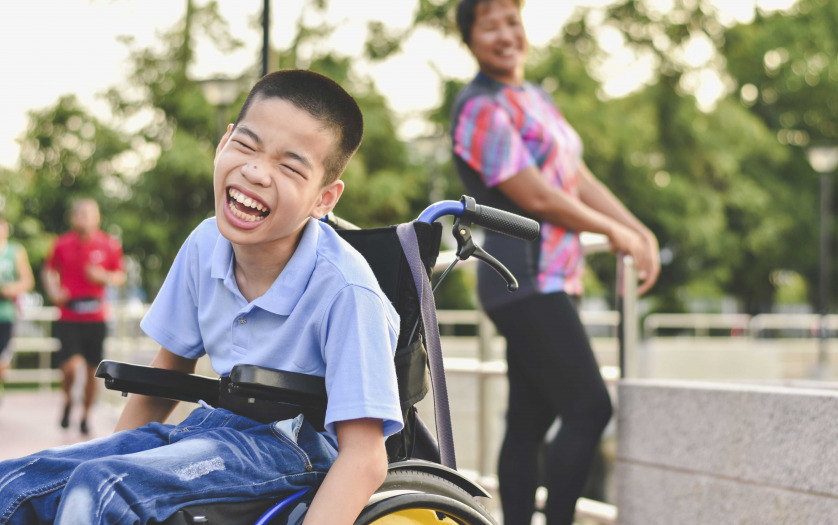 a kid in wheelchair smiling