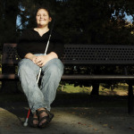 a blind woman sitting in the park