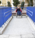 women in wheelchair leaving a building